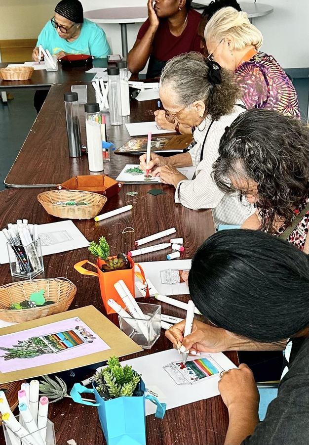 Residents working on their terrarium artwork at a senior residence