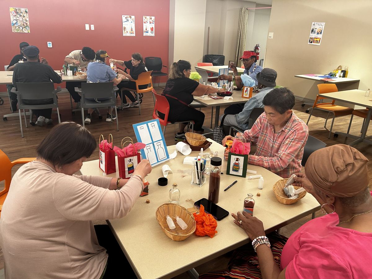 A full room of people working at tables at Millbrook Terrace