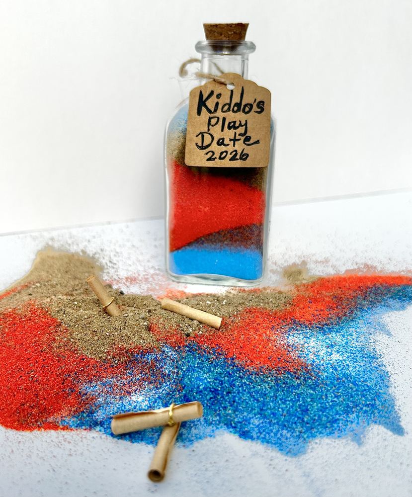 A finished layered sand bottle labelled Kiddo&rsquo;s Play Date
