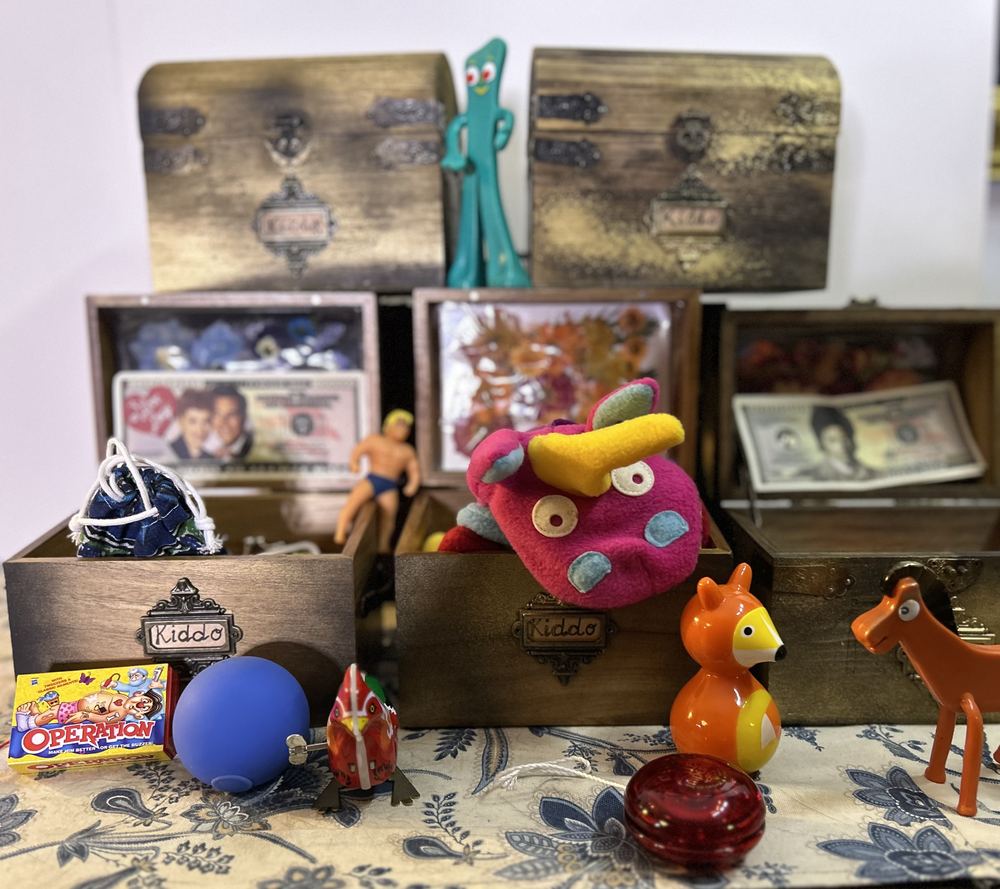 Open Show and Tell boxes filled with toys, old photographs and keepsakes