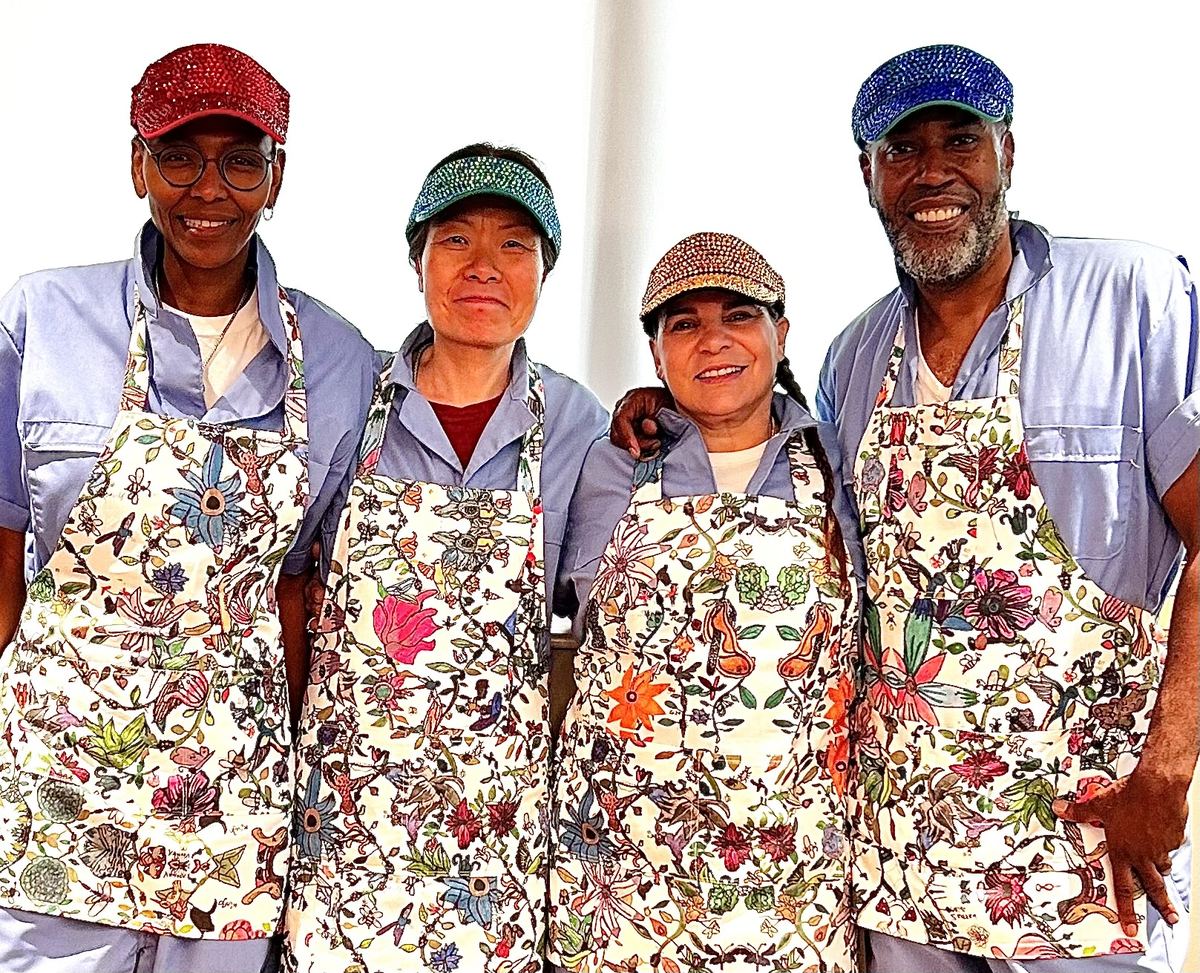 Four Kiddos standing together in matching floral aprons and caps